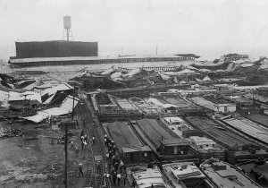 Wrecked_warehouses_and_scattered_debris_after_the_Black_Tom_Explosion,_1916.jpg