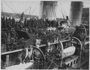 1280px-15th_Infantry_fighters_home_with_War_Crosses._French_liner_La_France_arrives_with_15th_...jpg