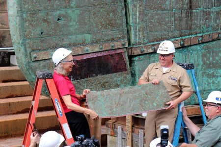 NHHC Detachment Boston Director Richard Moore ceremoniously remove the first piece of copper s...jpg