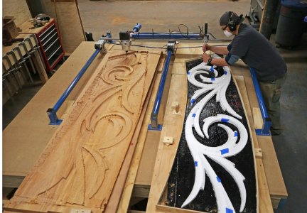 Ship restorer Joshua Ratty duplicated a 1927 bow trailboard by using a carving duplicate devic...jpg