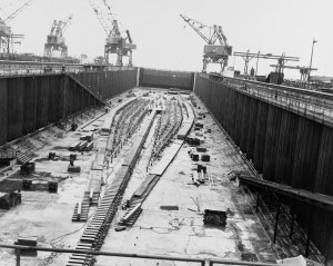 1280px-The_keel_plate_of_USS_United_States_(CVA-58)_being_laid_in_a_construction_dry_dock_on_1...jpg